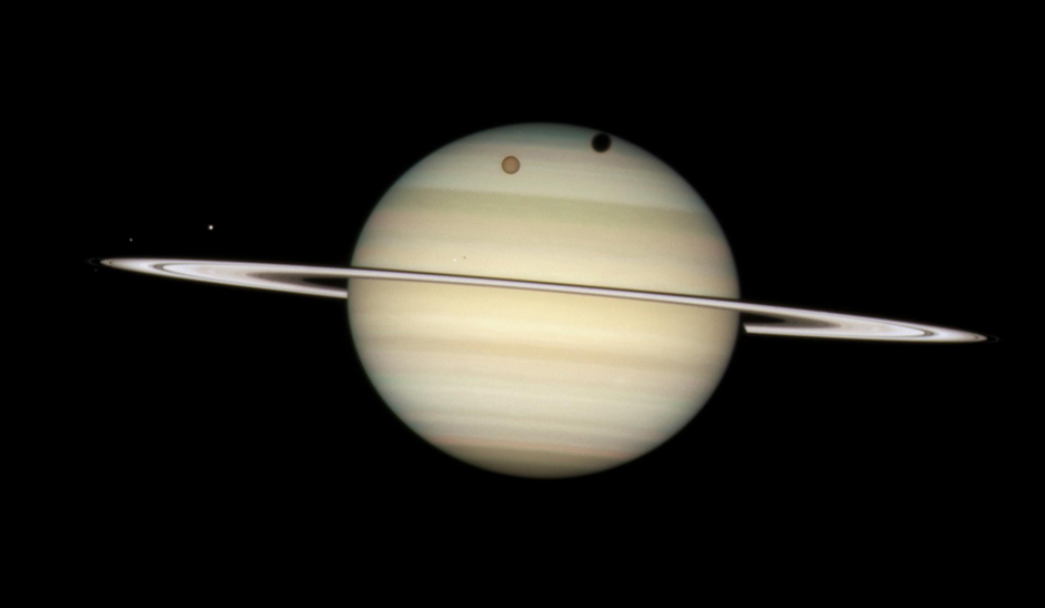 Bright Saturn tilted slightly right, with Titan in upper northern hemisphere