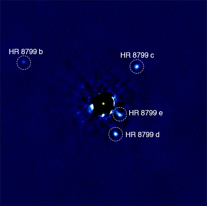 Four bright spots around a black disk covering a star