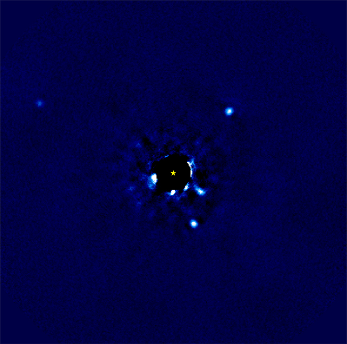 Four bright spots around a black disk covering a star