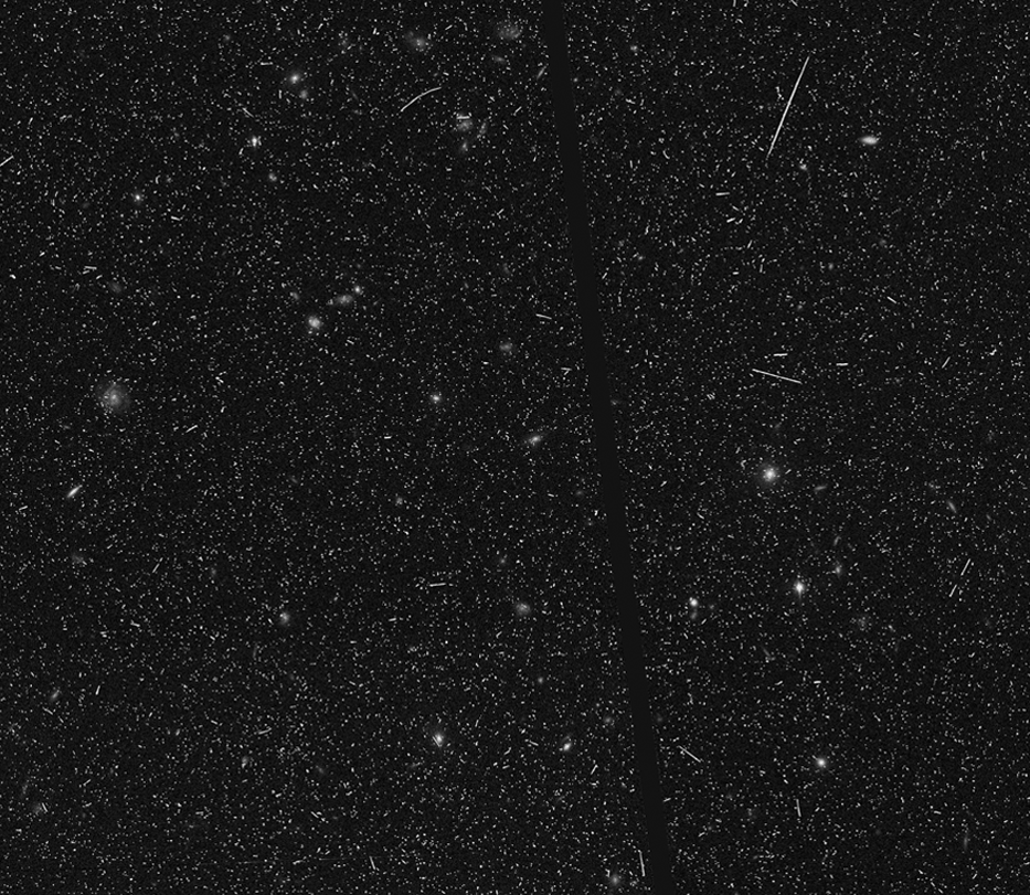 Scattered specks and lines; thick dark line crossing image