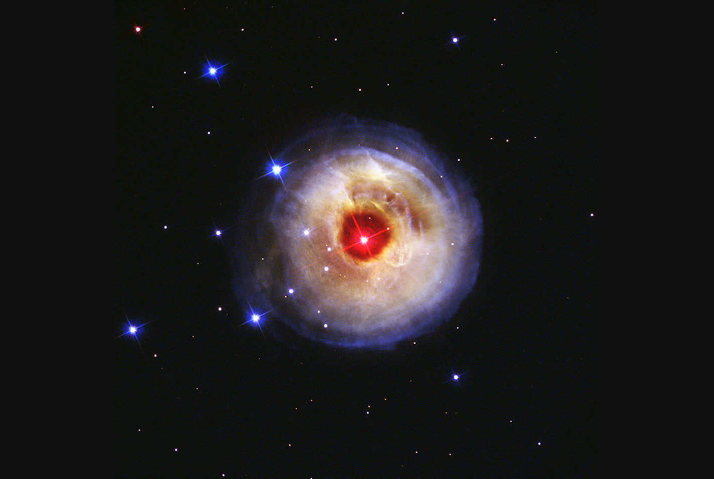 A central star is surrounded by circular layers of dust