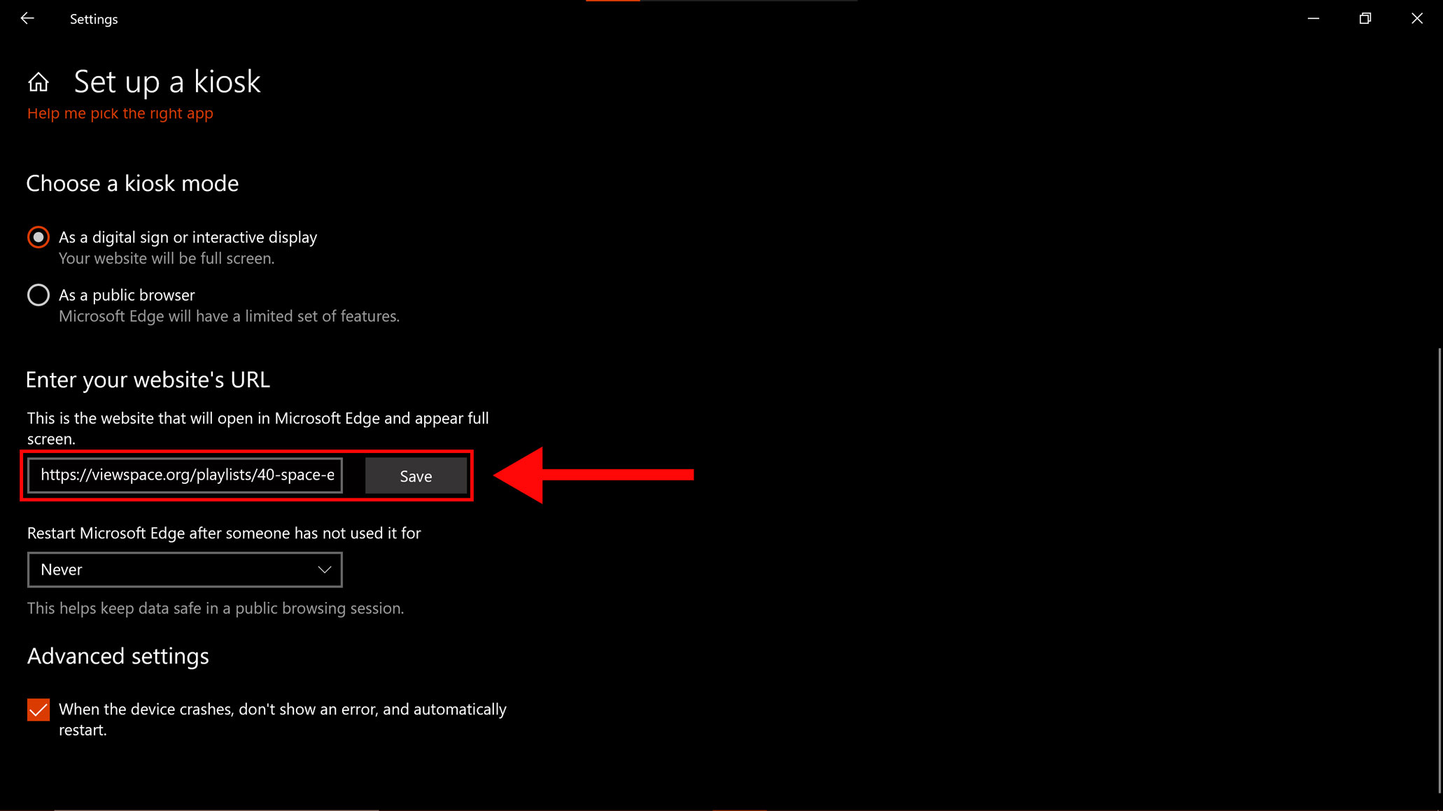 Screenshot of the Windows “Set up a kiosk” window. Just below is the “Choose a kiosk mode” section, which lists two options. The first option - “As a digital sign or interactive display” - is selected. Further below is the “Enter your website’s URL” section, which has two text entry boxes. A large red arrow points to the first box - "This is the website that will open in Microsoft Edge and appear full screen." - which has text entered that reads “ViewSpace URL Goes Here.”  A red rectangle also highlights this box. The next  "Restart Microsoft Edge after someone has not used it for" text box has “12 hours” selected from the drop-down menu. At the bottom of the screen, beneath “Advanced settings" the "When the device crashes, don't show an error, and automatically restart" checkbox is selected.