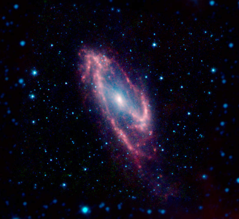 As each slider bar is manipulated, the view transitions from visible light to infrared light to near infrared light. In visible light: This galaxy is obscured behind a dust cloud. In infrared light: Slightly longer wavelengths of infrared light can penetrate the dust. In near infrared light: Even longer infrared wavelengths show us the dust features of the hidden galaxy.