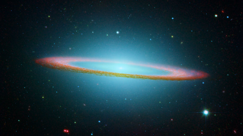 As each slider bar is manipulated, the view transitions from visible light to infrared light. In visible light: The dust ring is partially hidden in the galaxy's visible-light glow. In infrared light: The galaxy's dust and inner flat disk are clear when viewing infrared.