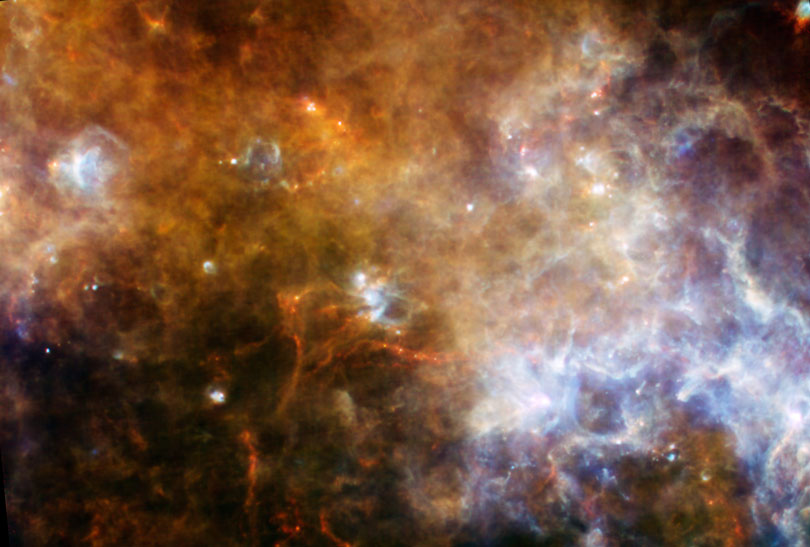 As each slider bar is manipulated, the view transitions from mid infrared light to far infrared light. In mid infrared light: Stars and dust glow alike as we peer deep into the Milky Way in mid-infrared light. In far infrared light: Extending to the far-infrared spectrum, we see the hot (blue) and very cold (red) dust in the galaxy.