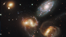 Four different types of galaxies with a background containing many more.