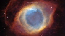 Image of the Helix Nebula: Misshapen oval with a central large blue circle surrounded by white and light orange circles.