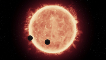 Illustration of a star with flares and two planets passing in front.